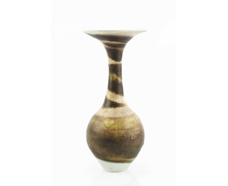 Lucie Rie (1902-1995)Vase, circa 1980with flared rim, spiralled dark and cream glazeimpressed potter's seal30.5cm high.Condit