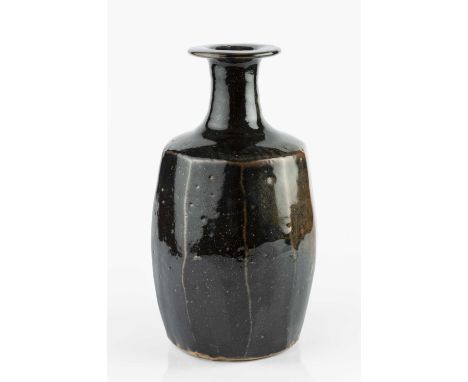 Trevor Corser (1938-2015) at Leach PotteryBottle vasetenmoku with faceted sidesimpressed potter's and pottery seals31cm high.