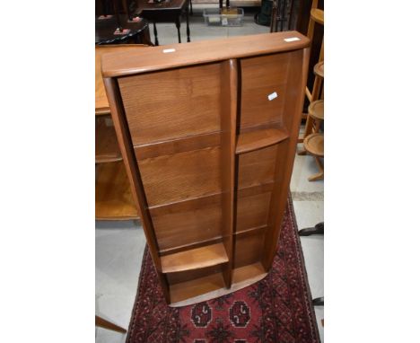 An Ercol mid stain wall shelf, width approx. 107cm