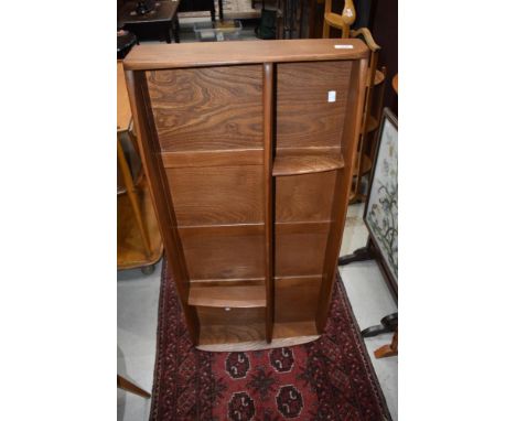 An Ercol mid stain wall shelf, width approx. 107cm