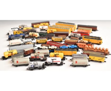 Fifty-nine Graham Farish, Lima or similar N gauge model railway goods wagons, brake vans etc including LMS, GWR etc.&nbsp;