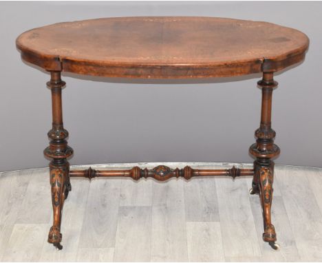 Victorian inlaid walnut hall table raised on turned supports united by a moulded, tapered stretcher and ceramic castors, W98 