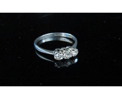 A three stone diamond ring on platinum shank, 0.28ct total approx. Size K, 1.8g 