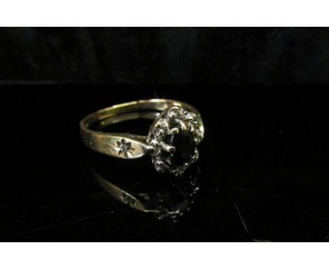 A 9ct gold sapphire and diamond chip cluster ring. Size N, 2g 