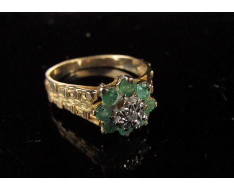 A 9ct gold emerald and diamond cluster ring with textured band. Size N, 2.9g 