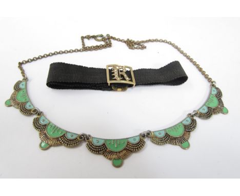 A 9ct gold monogrammed black ribbon bracelet with the initial "R" and an Art Nouveau style panel bracelet 