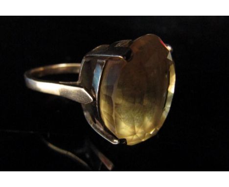 An unmarked gold ring set with a large oval citrine in high mount. Size P/Q, 8.5g 