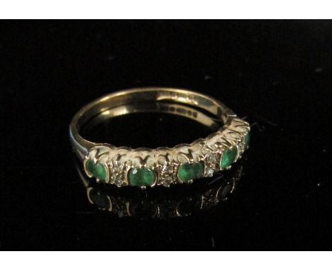 A 9ct gold emerald and diamond half hoop ring. Size M, 1.5g 