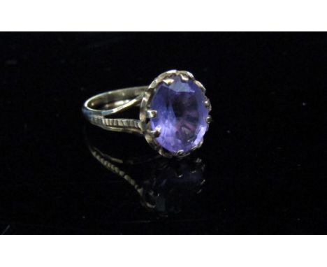 A 9ct gold ring with an oval amethyst, open shoulders. Size J/K, 1.9g 