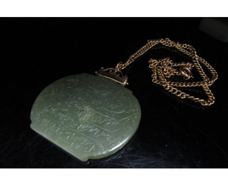 A large jade pendant with script, 5cm x 6cm hung on an unmarked gold chain, 46cm long, 7.4g 