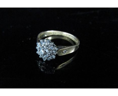 A 9ct gold diamond cluster ring with single diamond to each shoulder. Size K, 2.1g 