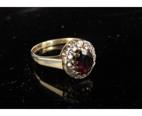 A 9ct gold garnet and cubic zirconia cluster ring. Size M, 2.4g 