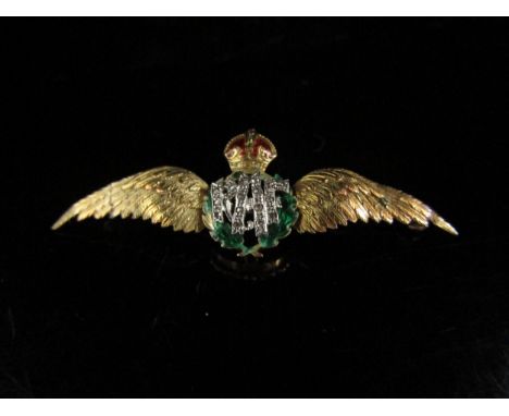 A yellow metal R.A.F sweetheart brooch, the R.A.F insignia set with diamonds, framed by a green enamel wreath (some damage to
