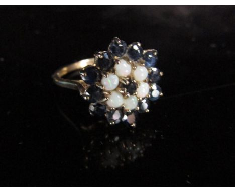 A 9ct gold sapphire and opal cluster ring. Size O/P, 3.1g 