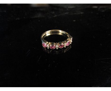 A 9ct gold ruby and diamond half hoop ring. Size L, 1.4g 