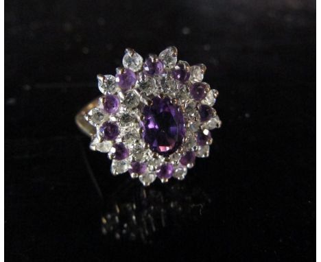 A 9ct gold amethyst and clear stone dress ring. Size O, 3.5g 