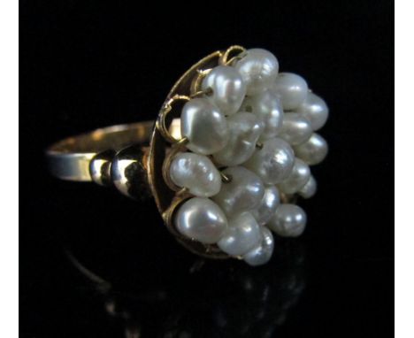 A gold ring with circular front with pearl wirework detail. Size O, unmarked, 4.1g 