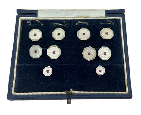 A cased octagonal white gold, mother of pearl and ruby cufflinks, button and studs set, S J Rose &amp; Son, 1956. Please see 