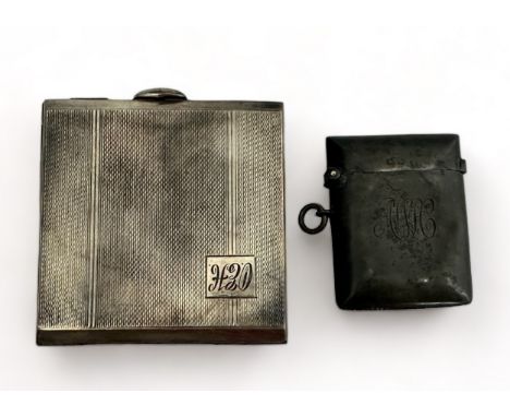 A silver compact and silver vesta case.  Silver compact with engine turned decoration and monogram to front. No mirror. Inter