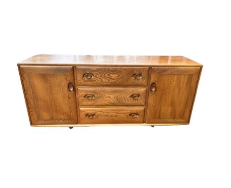 Ercol - mid-20th century elm 'Windsor' sideboard fitted with three drawers flanked by two cupboards, on castors. Width 156cm,