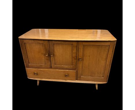 An Ercol model 366 Windsor elm sideboard, fitted with a double door cupboard, a single drawer and a further single cupboard w