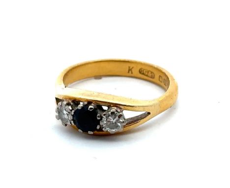 A 22ct gold, sapphire and diamond ring, size R. Central sapphire of approx 4.2mm diameter is flanked by diamonds on each side