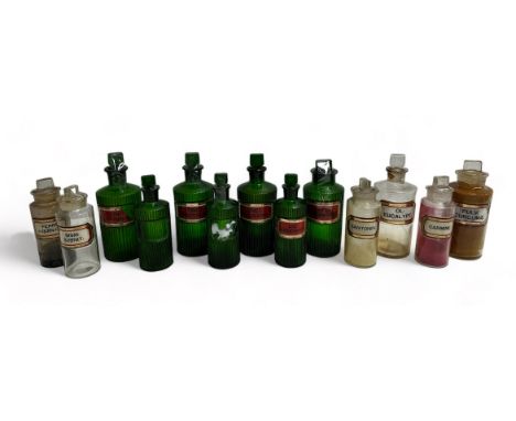 13 Apothecary Jars: Seven green jars with fluted sides and chisel stoppers, 3 are 21cm x 8cm, one is 19cm x 8cm and Three are