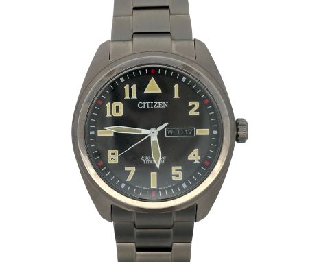 Citizen Eco Drive Titanium - E101-S125774 wristwatch. Black dial with Arabic numeral hands/ baron markers. Day/ date display.