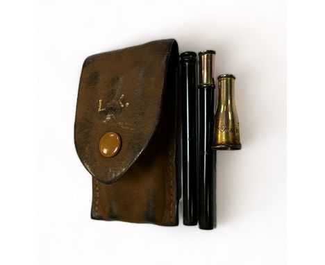 Dunhill London, early 20th Century small gold mounted cigarette holder, contained within a leather sleeve. Three pieces that 