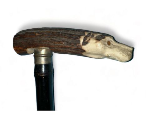 Ebonised sword stick with antler handle depicting a dogs head at one end of the handle and a flower etched into the other end