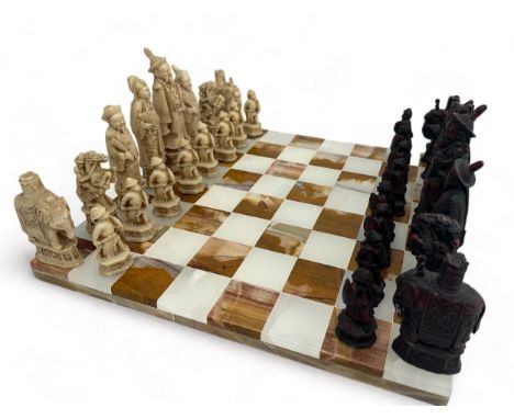 A marble chess board together with a set of resin Chinese style chess figures. Some of the resin figures with chips/ wear.  O