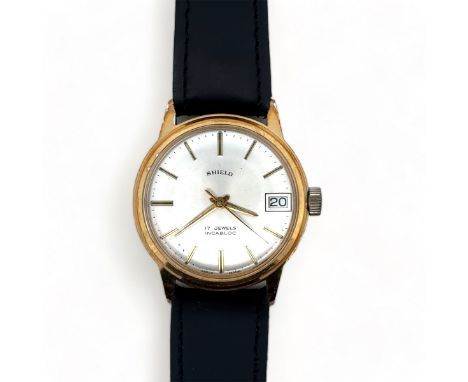 A 1960s Shield 17 jewel manual date watch with gold plated case, silver dial and baton hour markers Watch is winding and tick