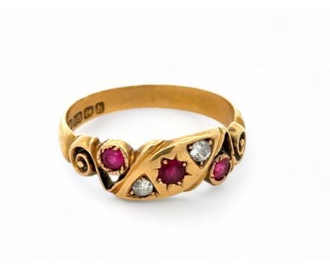 An 18ct gold ruby and diamond gypsy ring with scroll shoulders. Size P. Birmingham 1907 hallmarks. 3.5g. Good condition for a