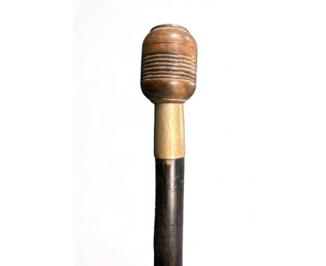 Ebonised walking Stick with unusual treen pommel that unscrews to reveal a space to store a coin. Stick length 88cm. 