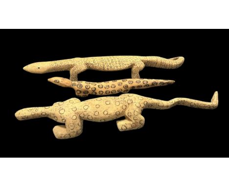 Three Aboriginal Carved Lizards possibly representing Goanna's, monitor lizards, one 87 x 15cm covered in small poker work ci