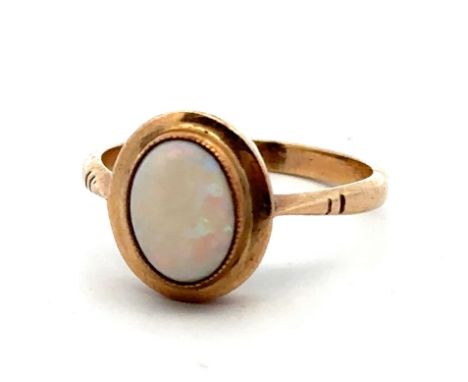 A gold and opal ring, stamped 9ct. Size O/P. Opal 9mm x 7mm and showing all colours of the spectrum - some surface abrasions 