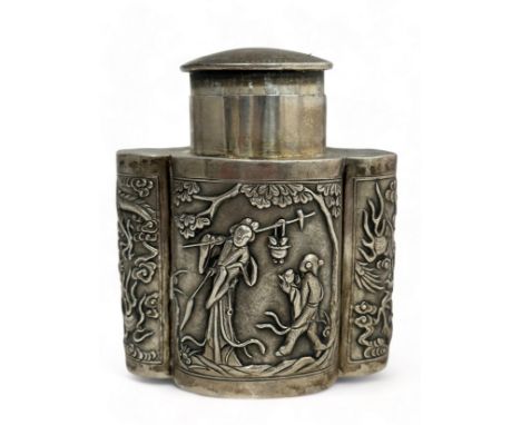 A Chinese export silver tea caddy in a quatrefoil form with lid, decorated with repousse scenes of figures and creatures on o