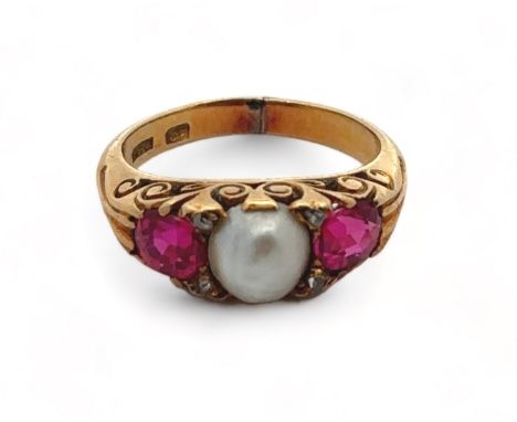 A ruby and pearl ring in an 18ct gold scroll setting, size I. Weight 5.4g. Signs of resizing/ repair to shank.