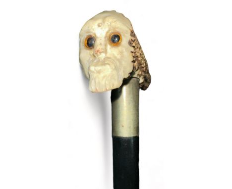 Ebonised walking Stick with antler handle depicting a skeletal head on one end of the handle. Stick length 91cm. 