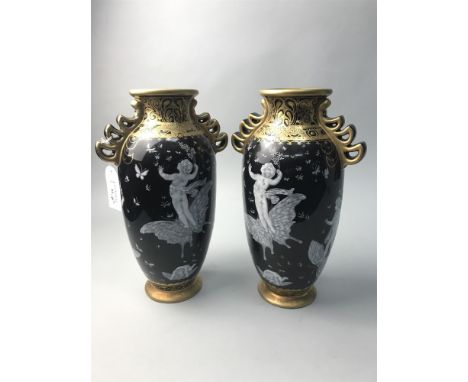 PAIR OF BLACK AND GILT VASES, decorated with cherubs and butterflies; along with two decorative ceramic egg shaped dishes