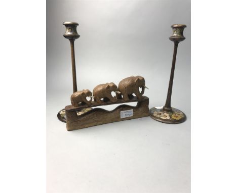 A TROUP OF THREE CARVED WOODEN ELEPHANTS, along with another elephant figure, a trinket box and pair of wooden candlesticks (