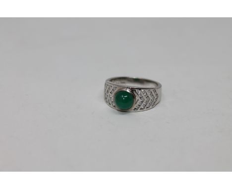 An 18ct white gold cabochon emerald and diamond ring, 6.55g