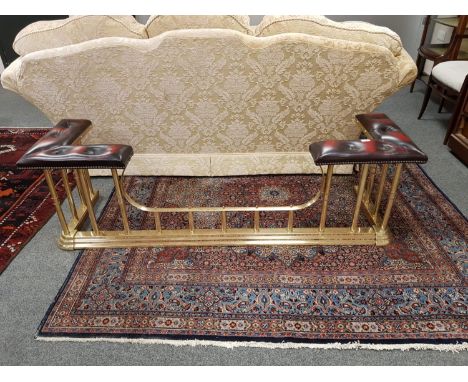 A good quality brass and Burgundy leather club fender, width 173 cm  CONDITION REPORT: The brass base measures 49cm deep by 1