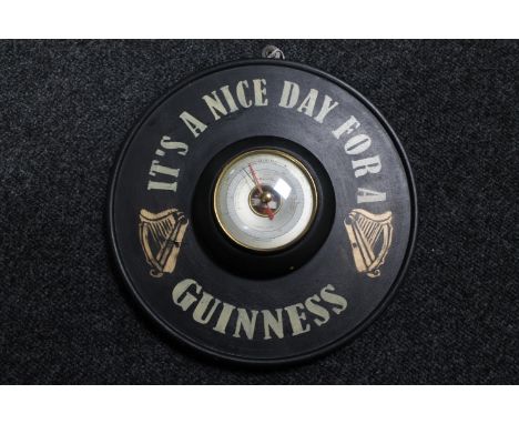 A circular Short &amp; Mason barometer mounted on board bearing Guinness advertising  