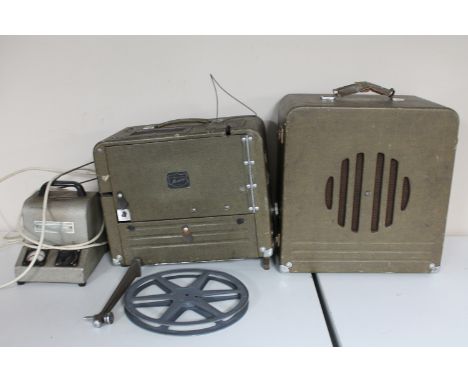 A vintage 16mm projector with power packs and speaker 