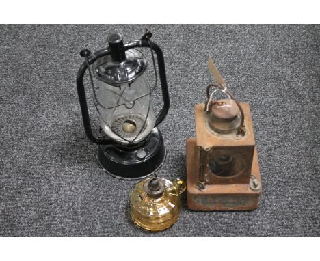 A vintage railway lamp, glass oil lamp base and one other oil lamp 