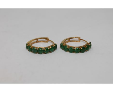 A pair of high carat gold mounted jade hoop earrings 