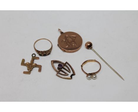 A 9ct gold locket, stick pin, two rings, swastika pendant etc 