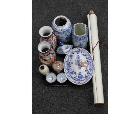 A tray of oriental wares including a scroll, blue and white lidded urn, hand fan, tureen, vases etc 