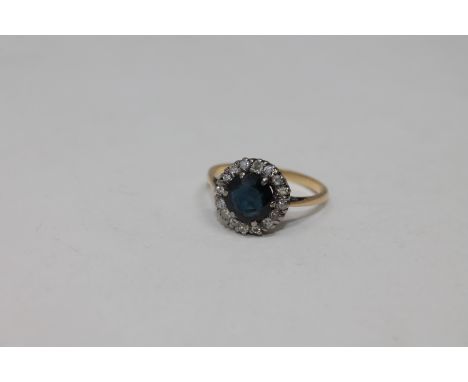 An 18ct gold sapphire and diamond cluster ring